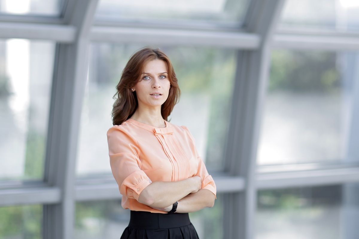 modern business woman standing near a large window in the office.